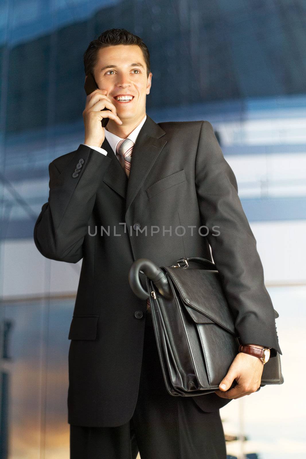 Businessman outside a modern building by DmitryYakunin