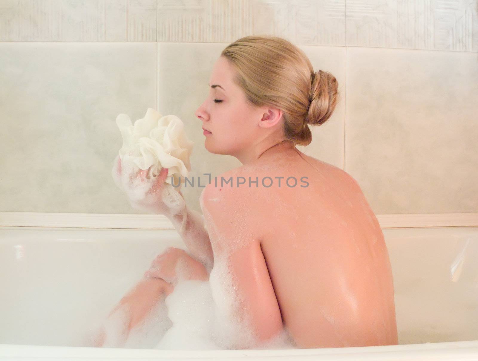 young beautiful girl in a bath with shower by Jim