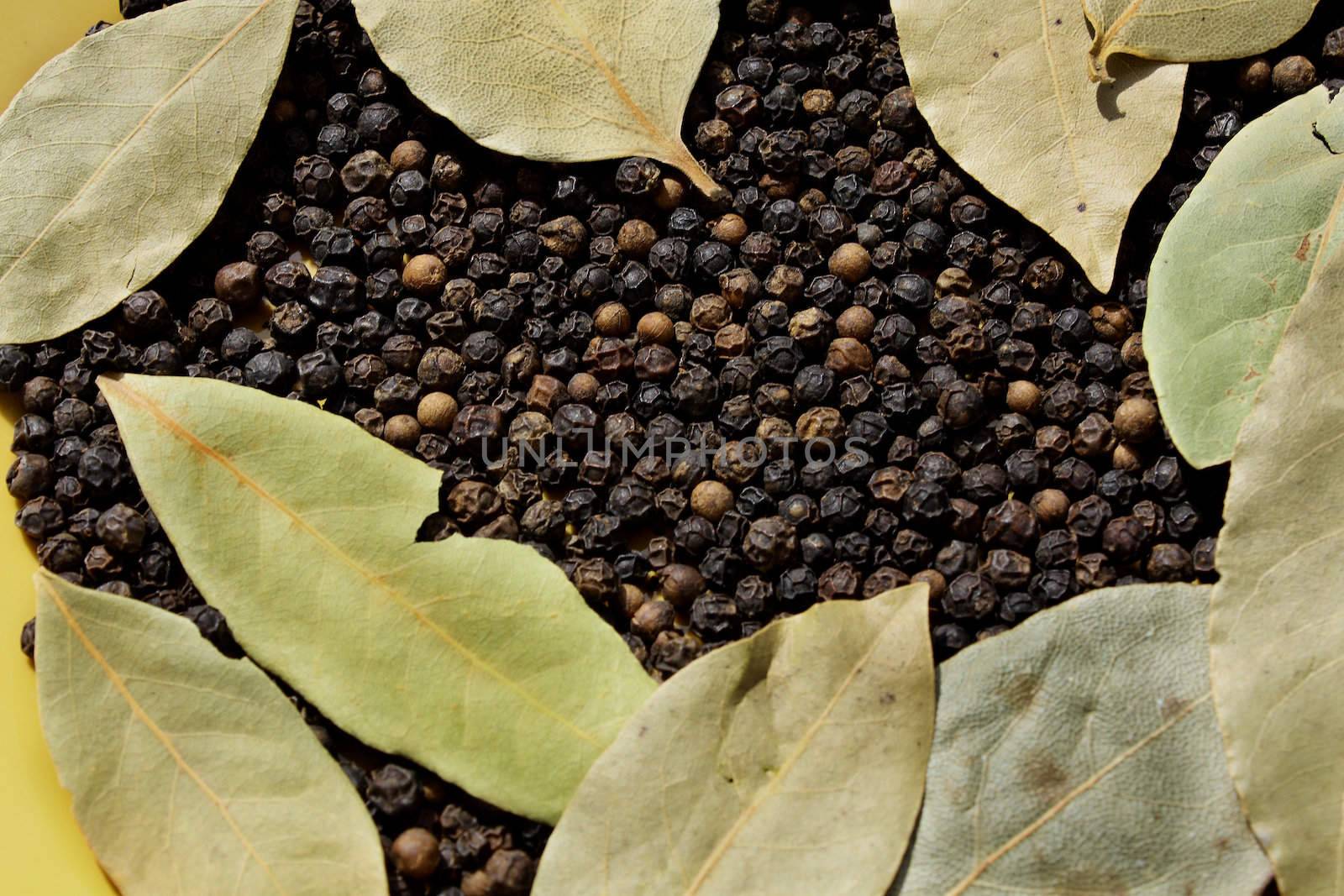 Close up of the bay leaves and black pepper.
