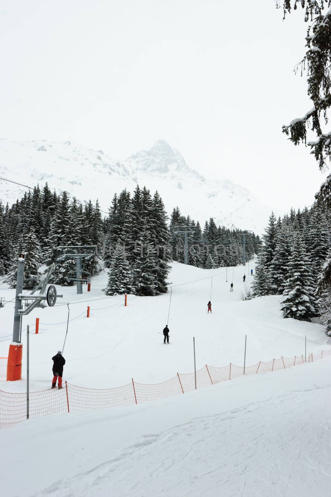 Platter lift with skiers at Meribel ski resort, France