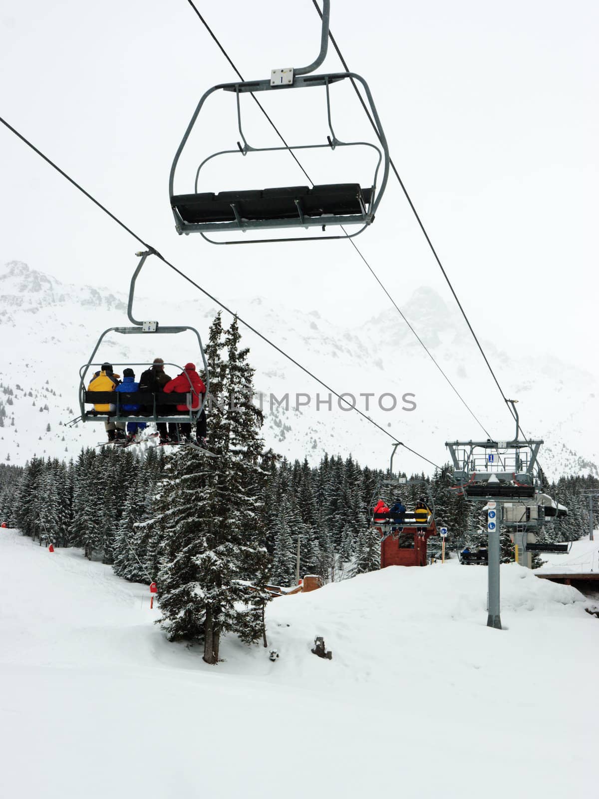 Chairlift with skiers at Meribel ski resort, France