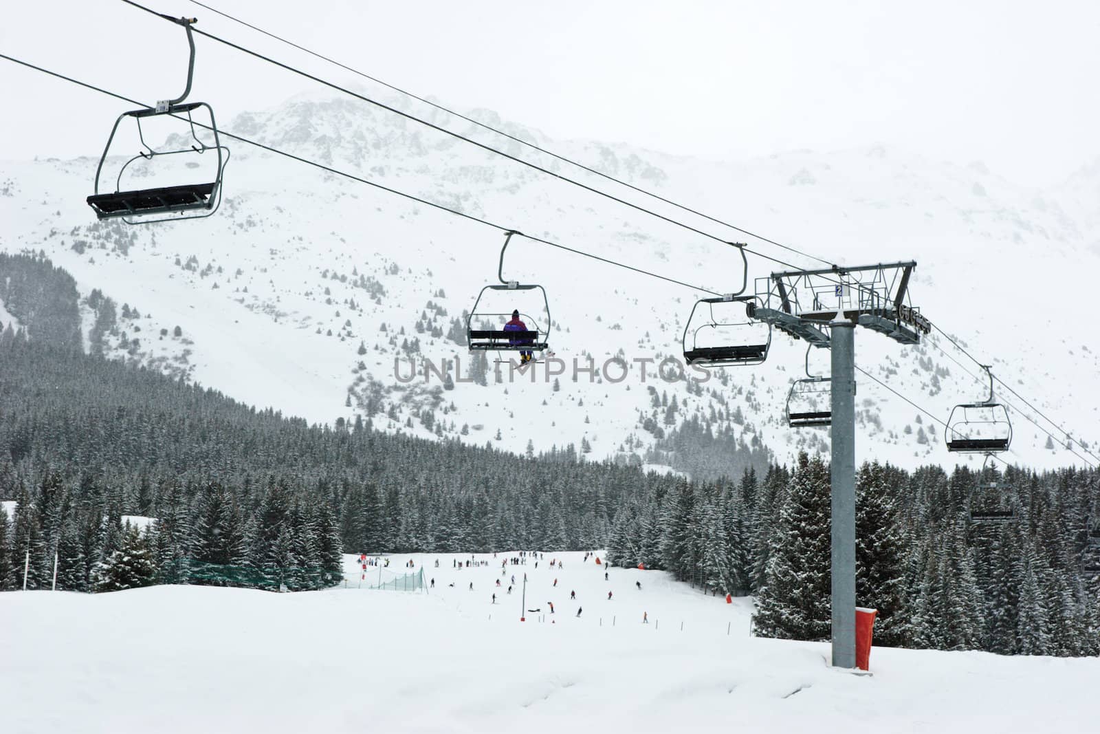 Chairlift with skier at Meribel ski resort, France