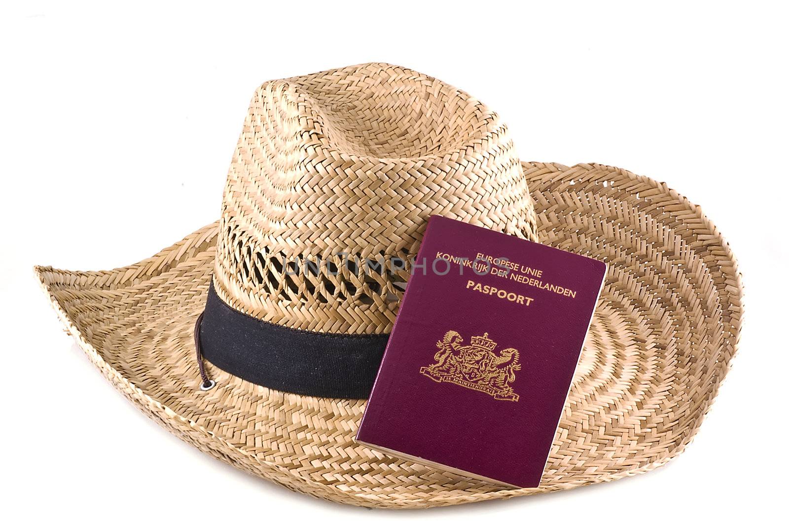 Straw hat with passport, isolated on a white background. 
