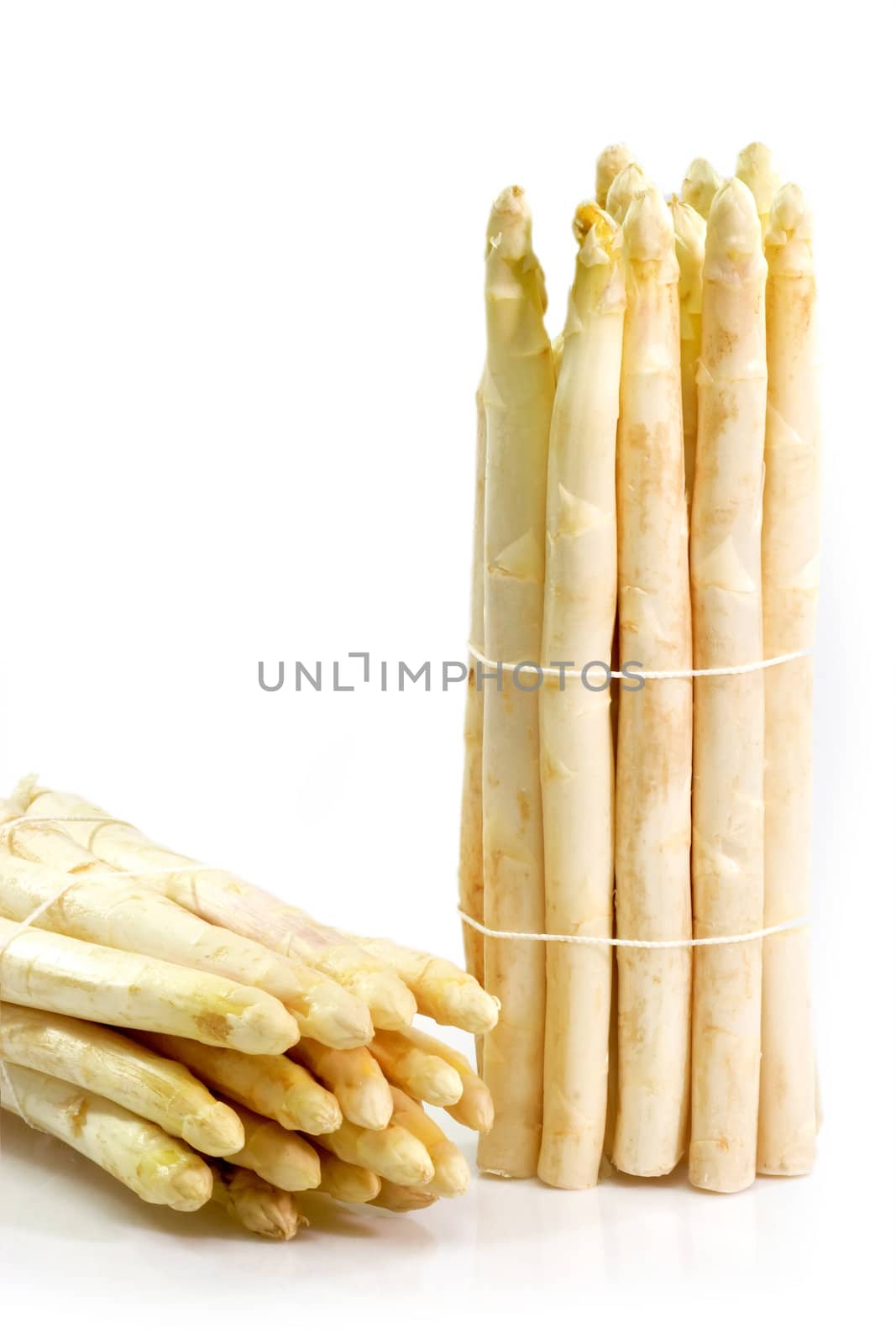 Bundle with fresh asparagus on bright background
