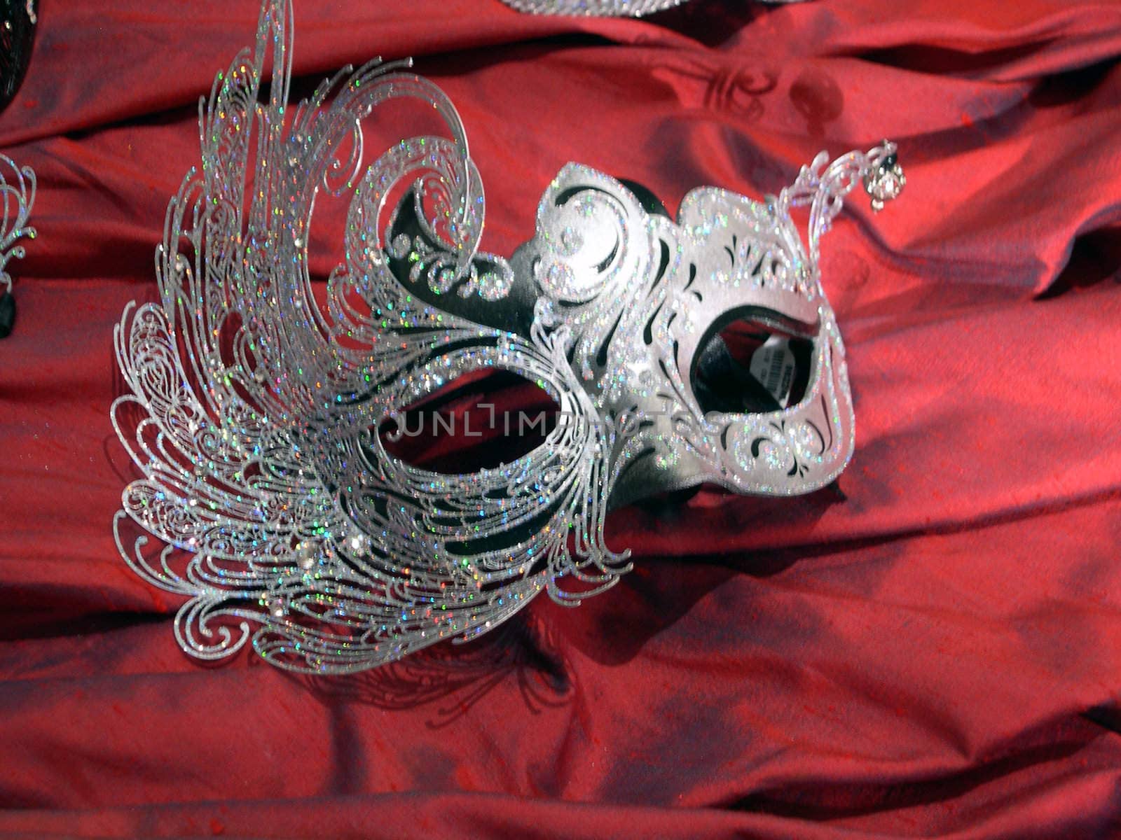 an elegant mask atop red velvet