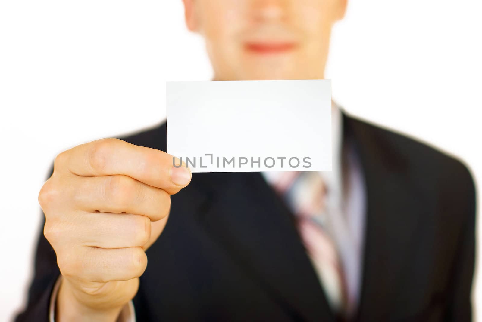 Young businessman holding blank card by DmitryYakunin