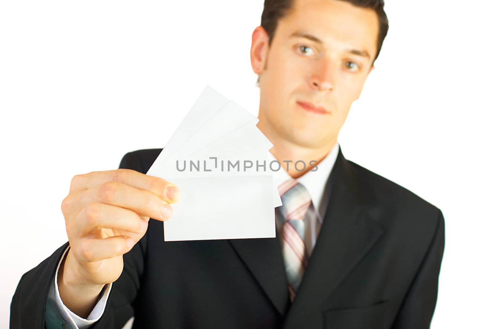 Young businessman holding blank visit card. Backside. Isolated.