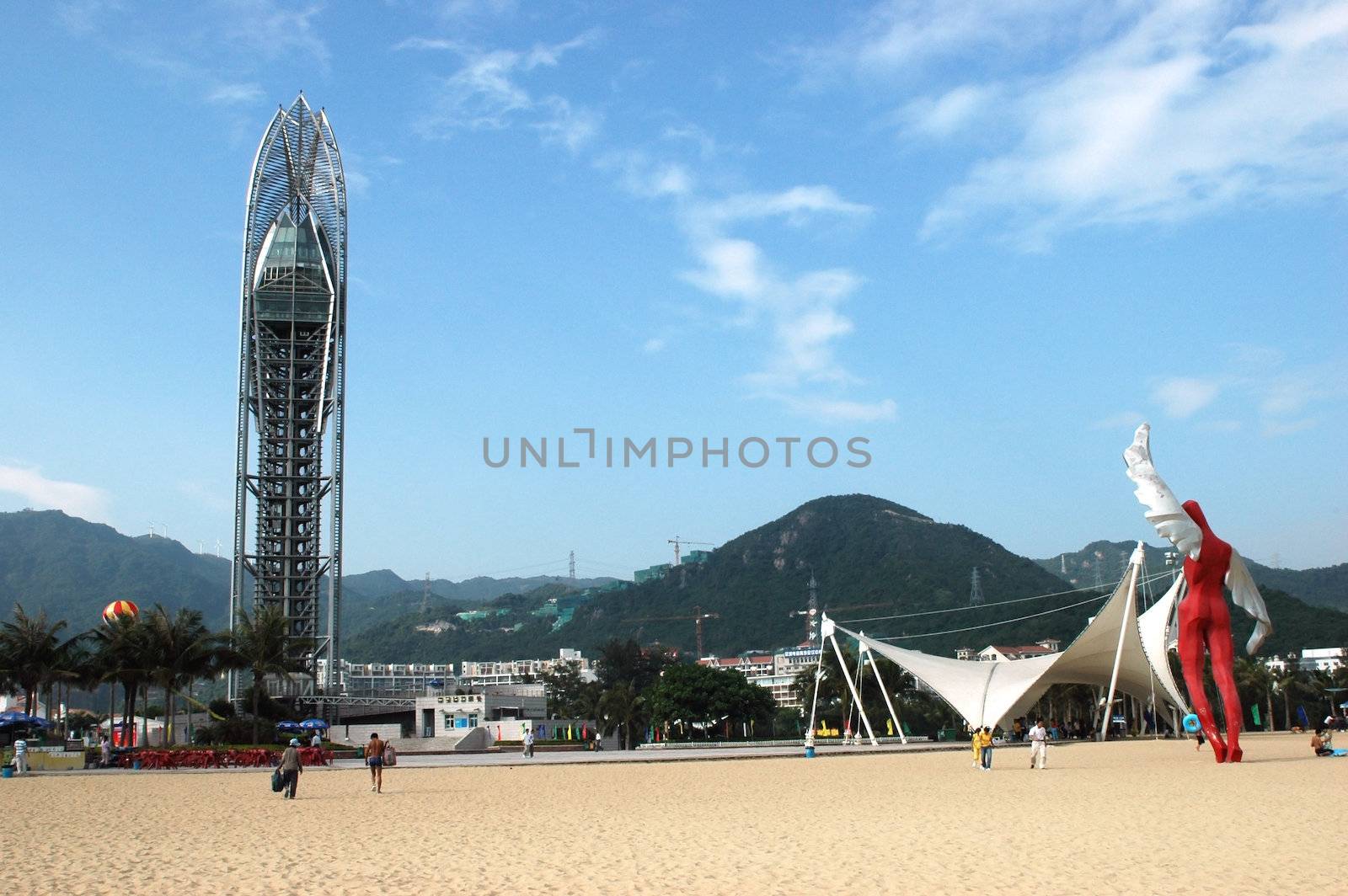 China South Sea, Guangdong province. Shenzhen city - sea side, wide beach with viewing tower at DaMeiSha. Large angels sculptures standing at the beach. 