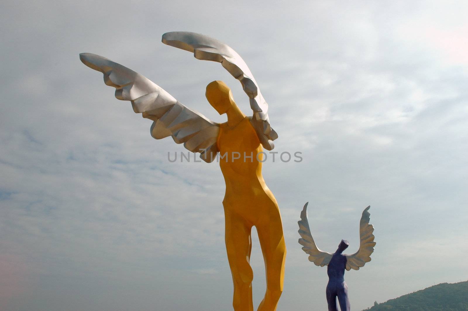 China South Sea, Guangdong province. Shenzhen city - sea side, wide beach at DaMeiSha. Large angels sculptures standing at the beach.