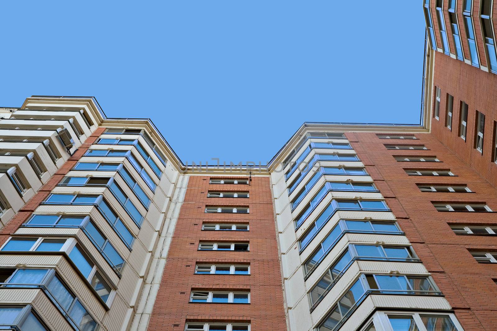 A residential multistory house and sky, view from below