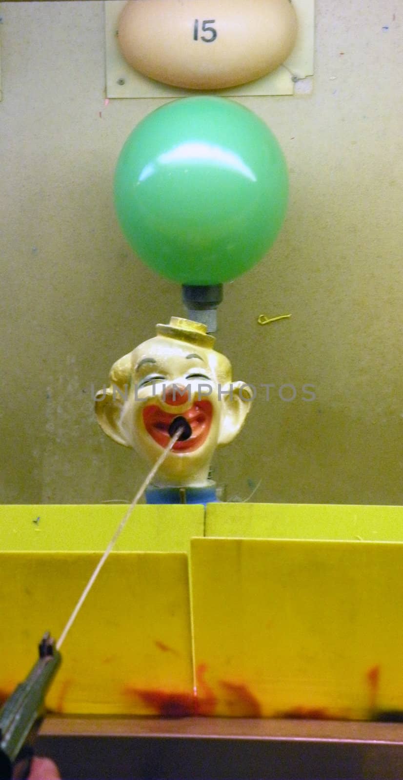 carnival game where you shoot the clown with a water pistol in order to inflate and pop the baloon to win a proze.