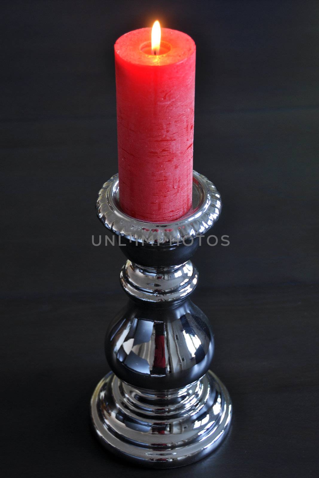 Burning red candle in silver holder by franky242