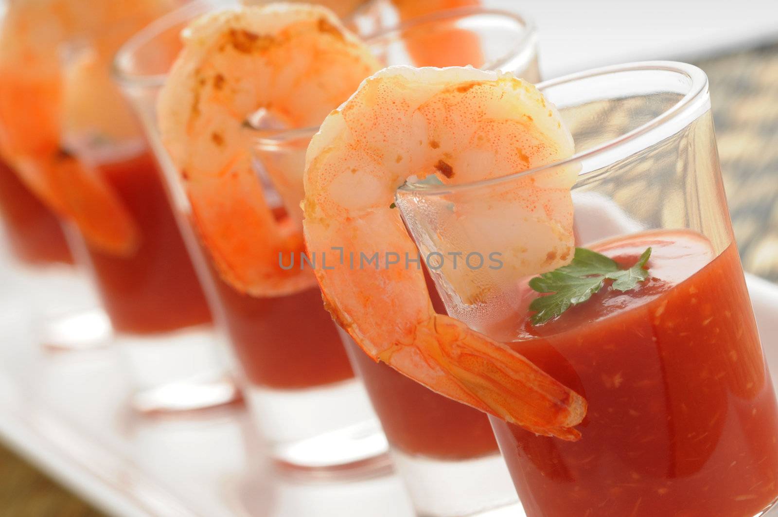 Shrimp cocktail in shot glass shot closeup.