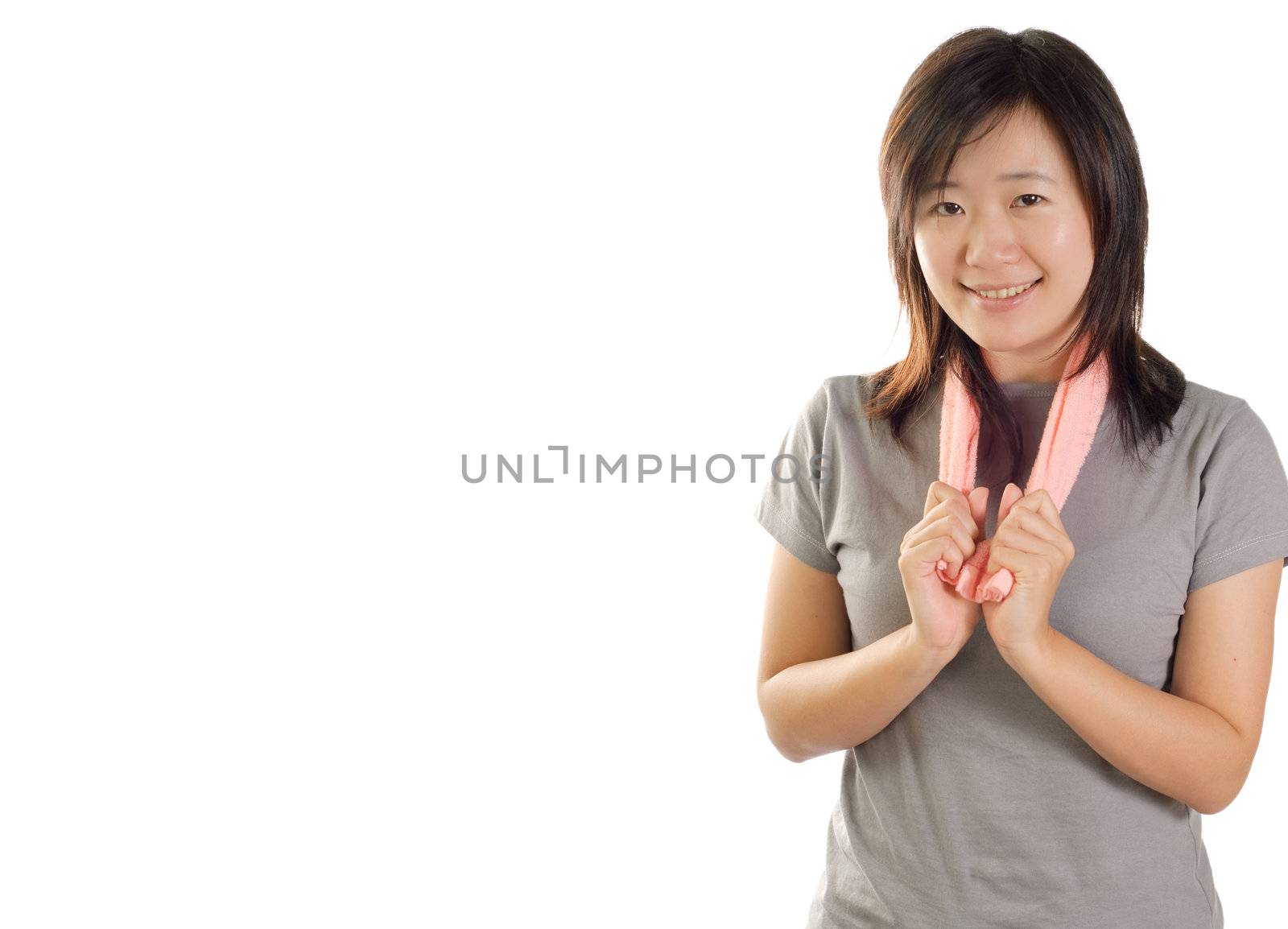 Asian sport girl holding pink tower showing beautiful smile on white background with copy space.