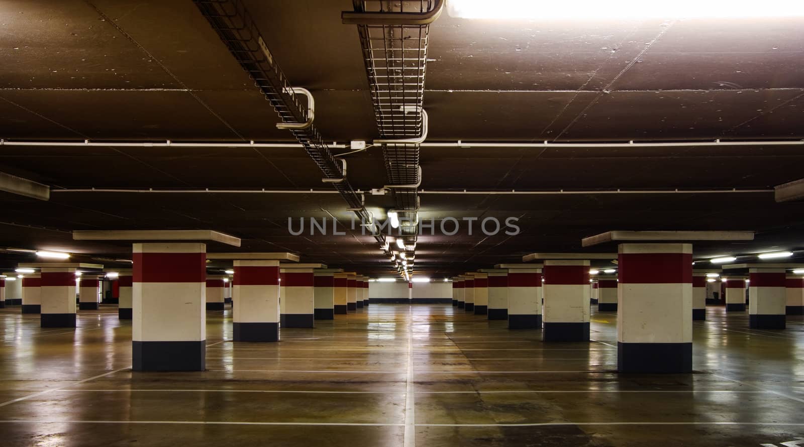 Empty underground parking, reflections on the floor