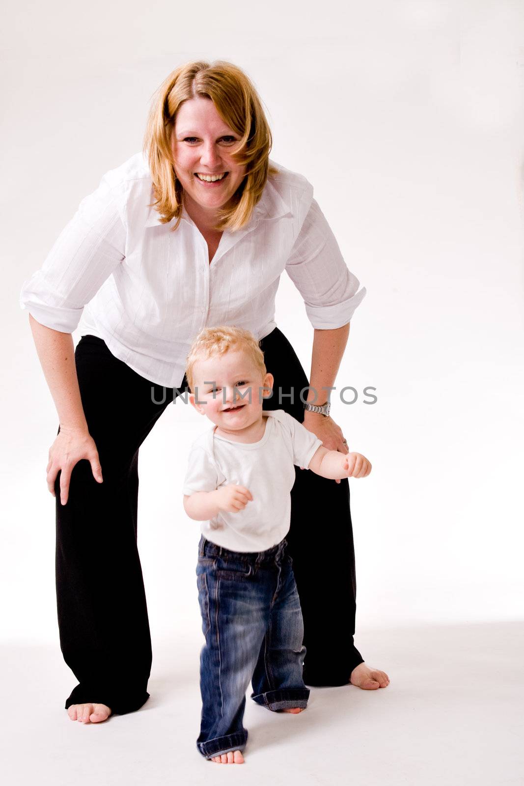 Cute caucasian blond toddler is happy with his mother