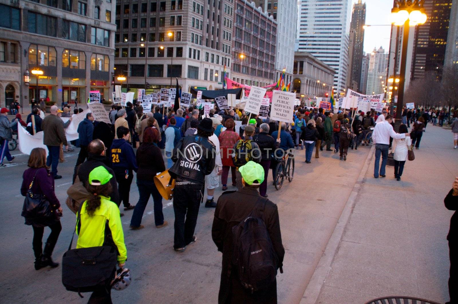 CHICAGO, IL-MAR. 18, 2010: Protesters march through downtown Chicago, demonstrating against US military involvement in Iraq and Afghanistan on March 18, 2010.