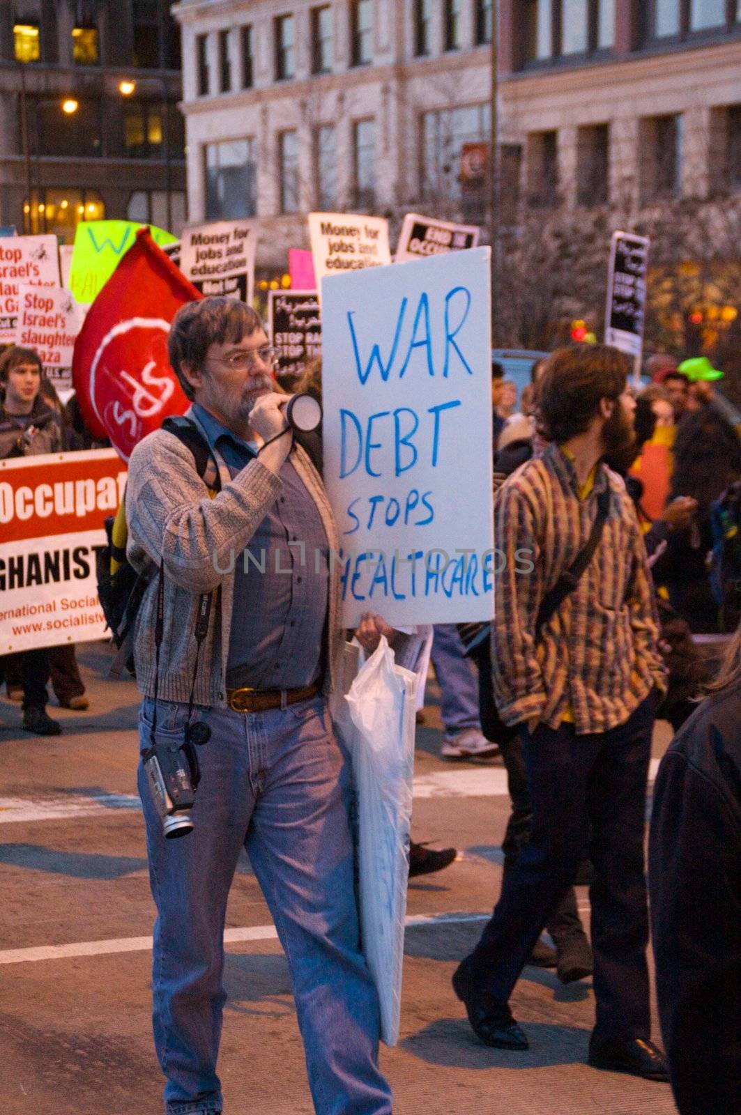 CHICAGO, IL-MAR. 18, 2010: Protesters march through downtown Chicago, demonstrating against US military involvement in Iraq and Afghanistan on March 18, 2010.