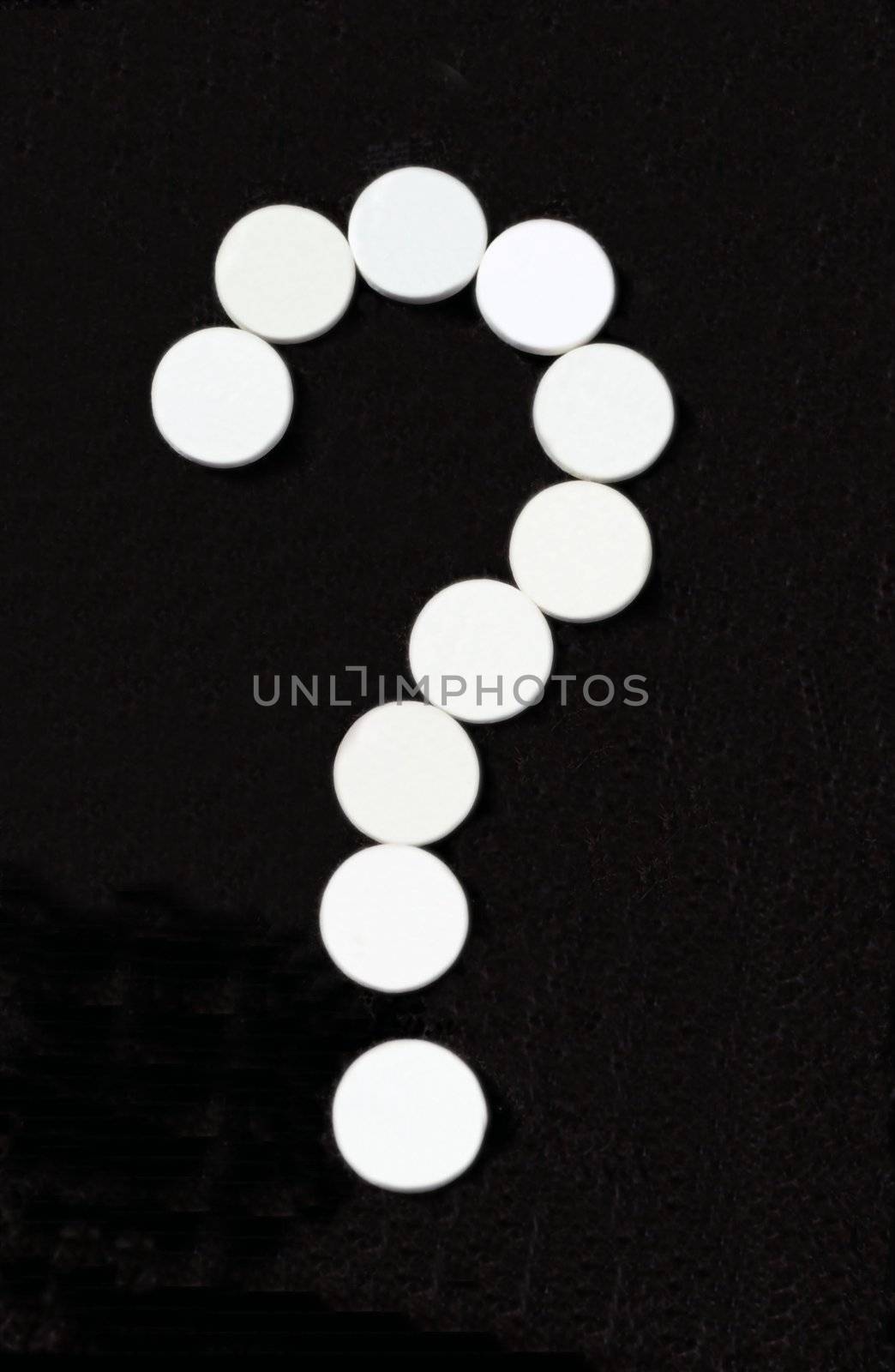 White pill question mark on black