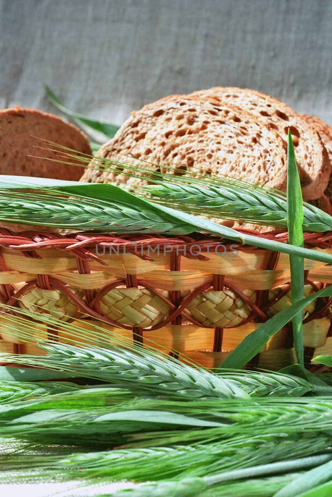 Spicas of rye and bread slices in basket