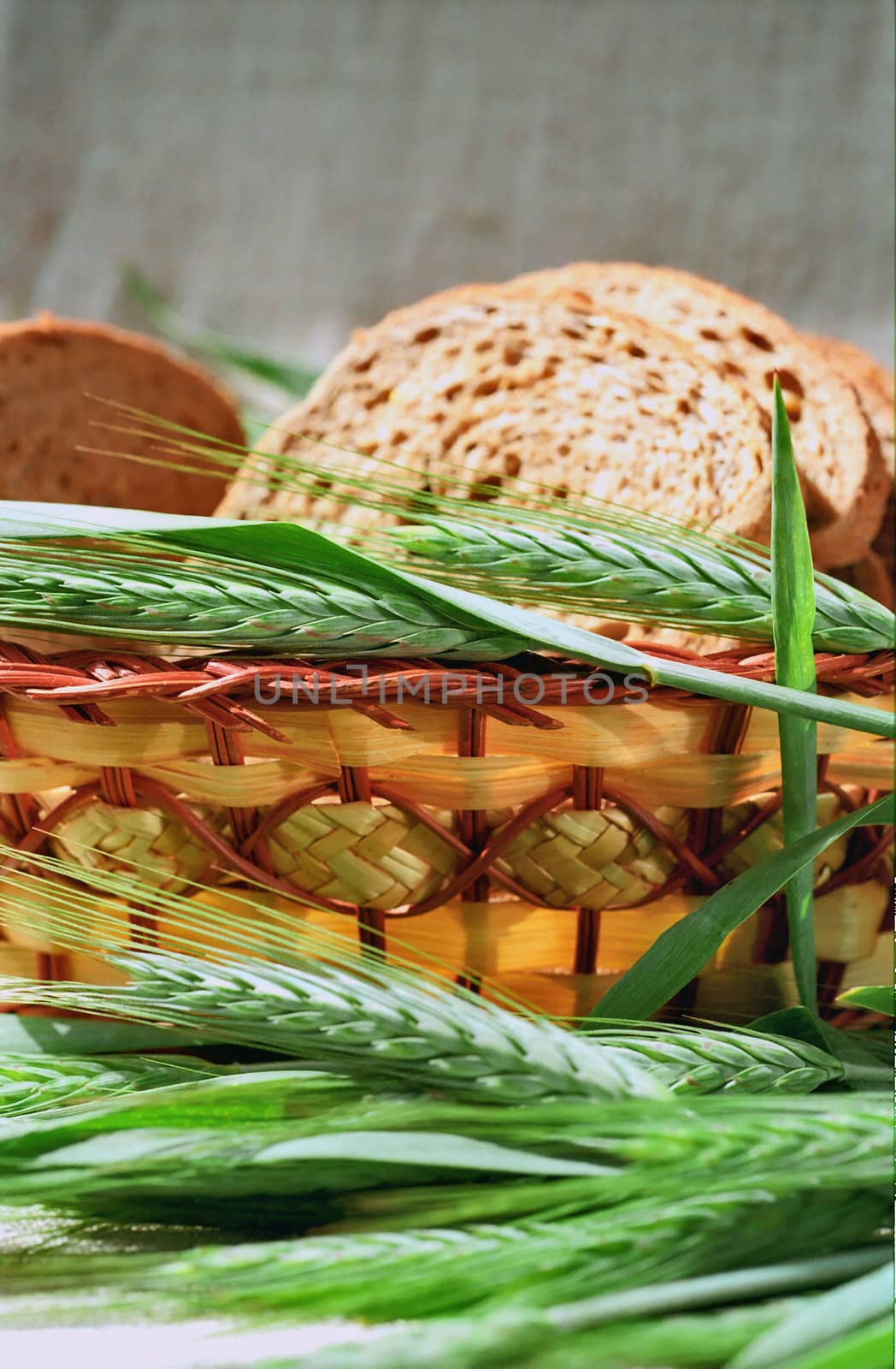 Spicas of rye and bread slices in basket