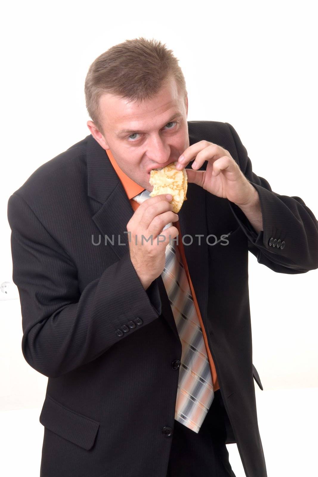 Hunger. The businessman eats a pancake on a white background.