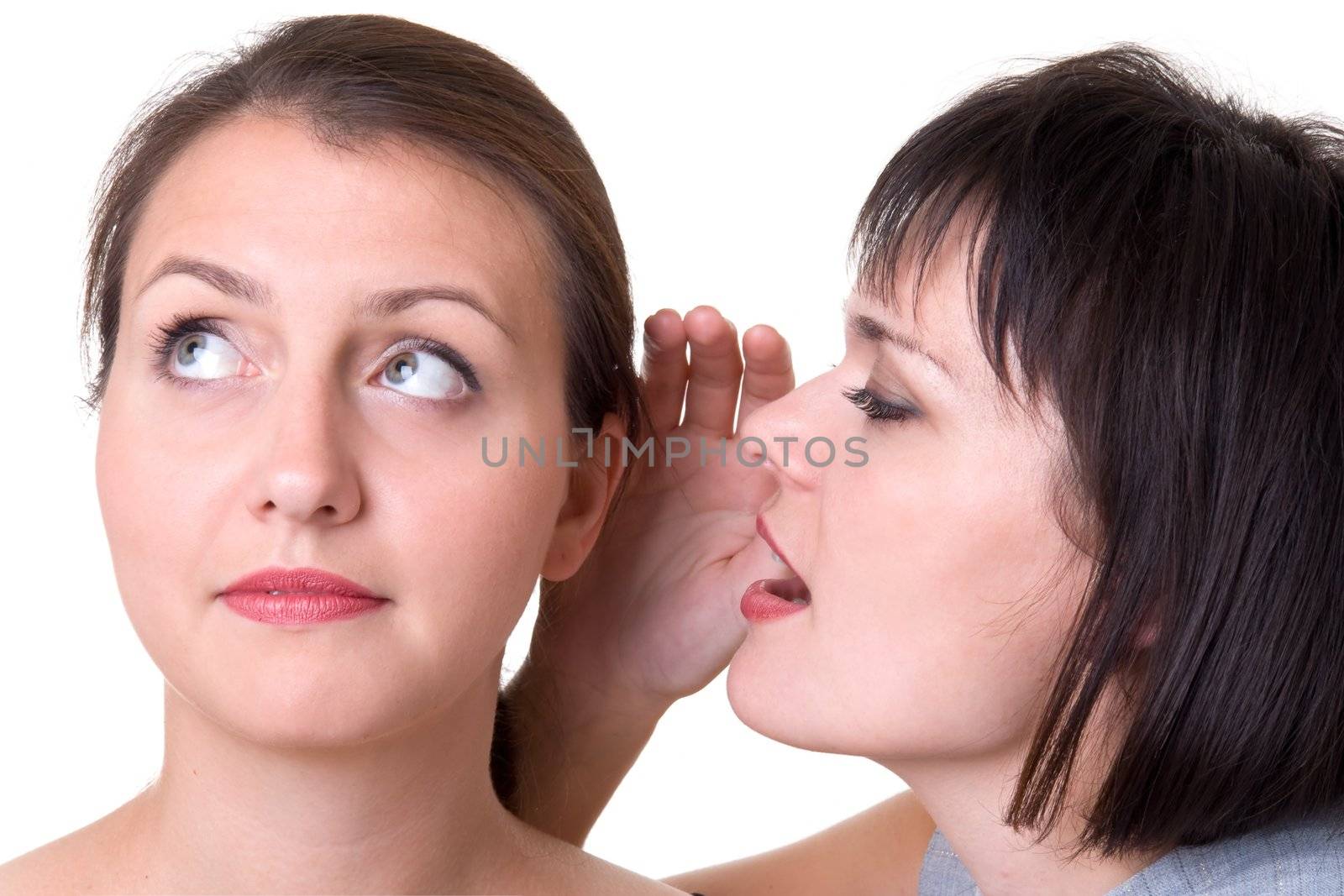 Whisper. Two beautiful girls gossip, isolated on white.