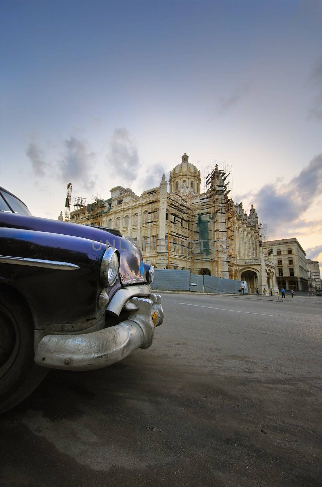 Old classic american car parked in front of Revolution Palace building in Havana, cuba
