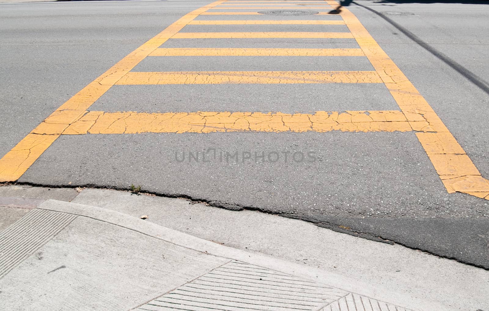 Old painted crosswalk, on a street in a city. It sure beats paying for gas.