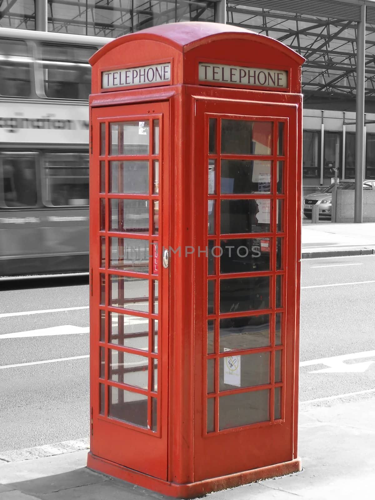 Traditional red telephone box in London, UK - selective black & white background