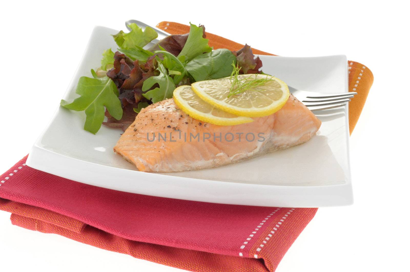 Poached salmon served with fresh greens and lemon.