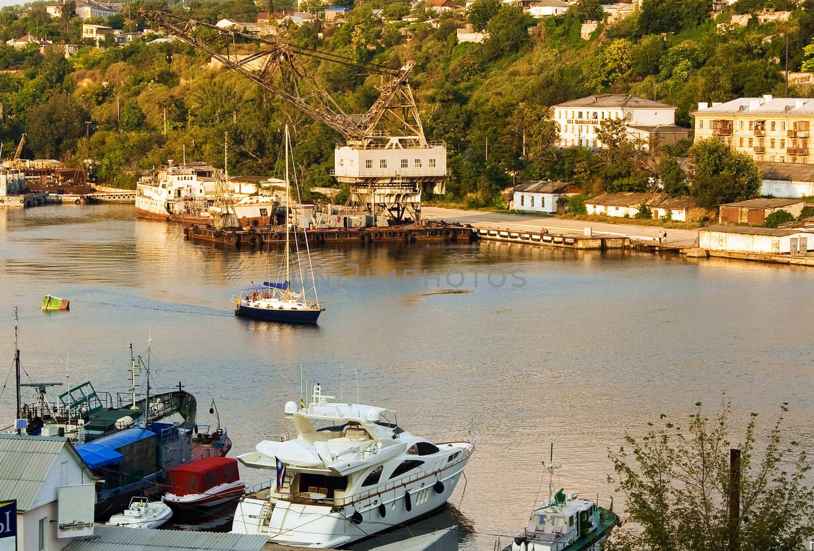 Marine travelers are in the bay. Soon their yacht berths to the shore, and then they will be able to replenish their stocks of food and water. On the shore they can relax.