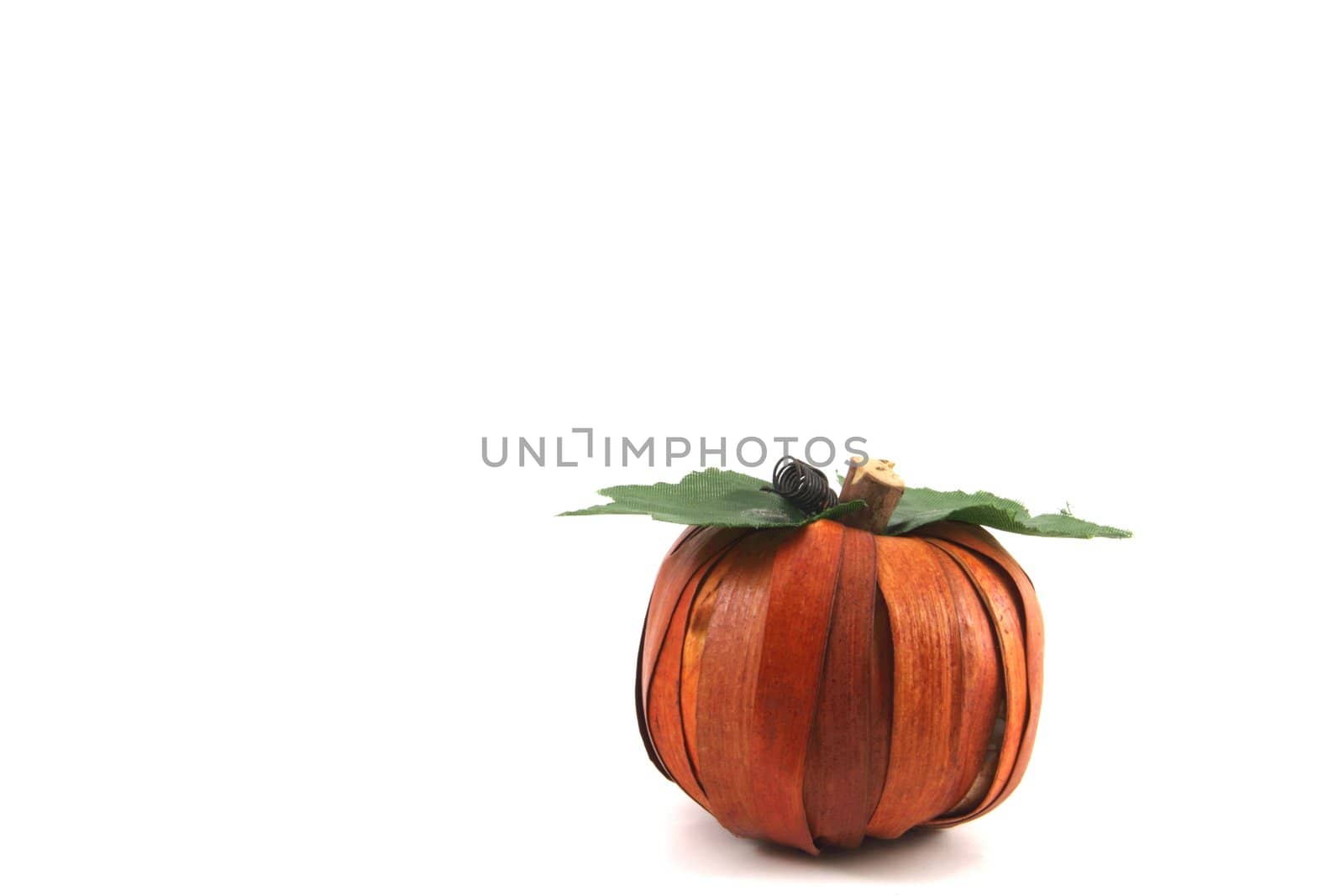 Artistic pumpkin fashioned from natural materials and isolated with copy space.
