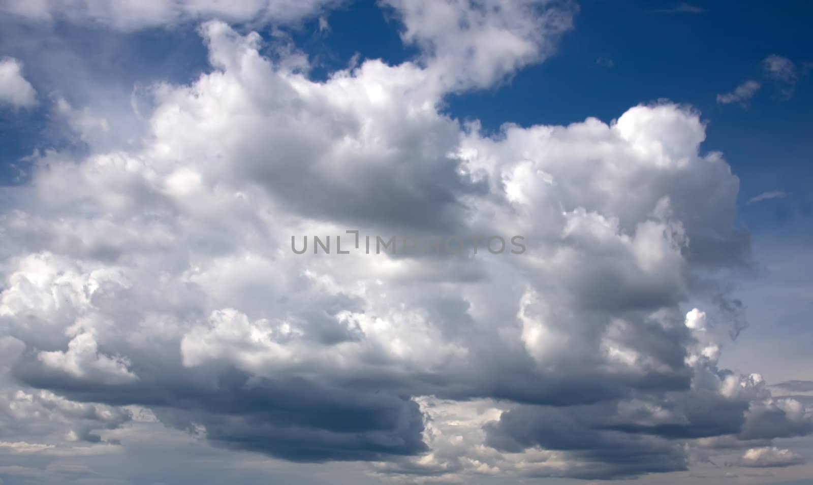 Big clouds in the blue sky in sunny weather