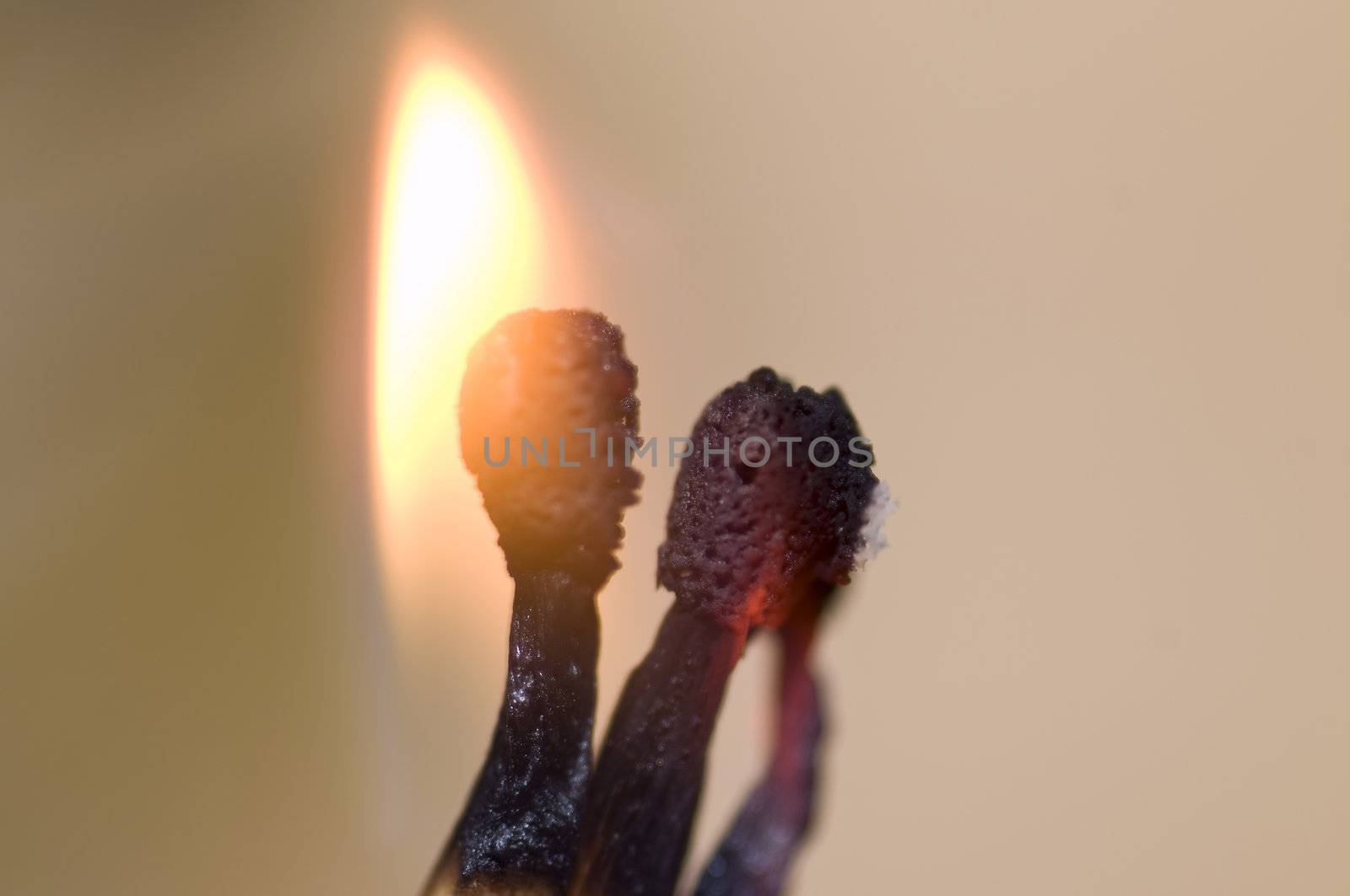 macro on burning matches on light wood background