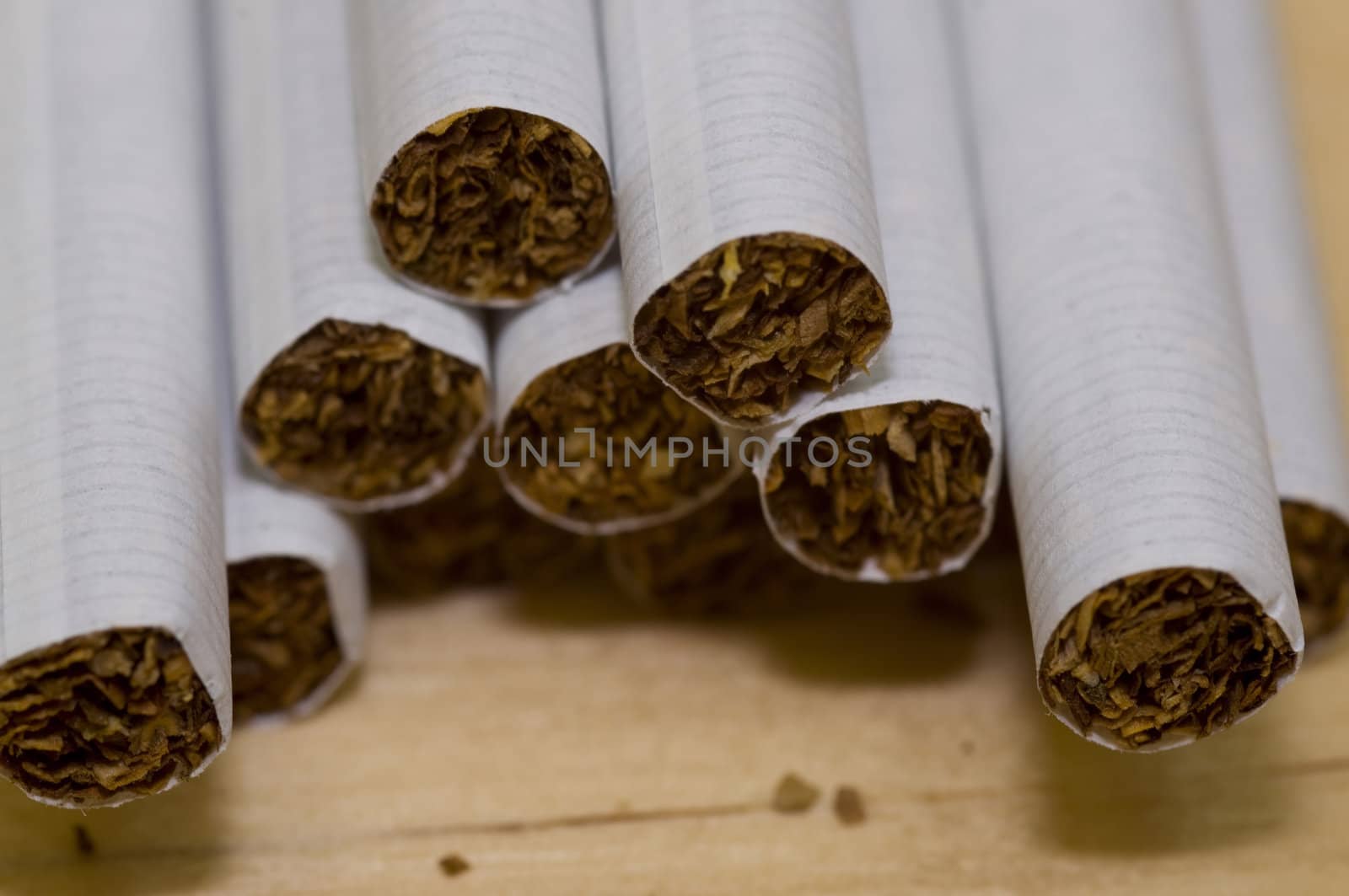 macro on cigarettes, on light color wood background