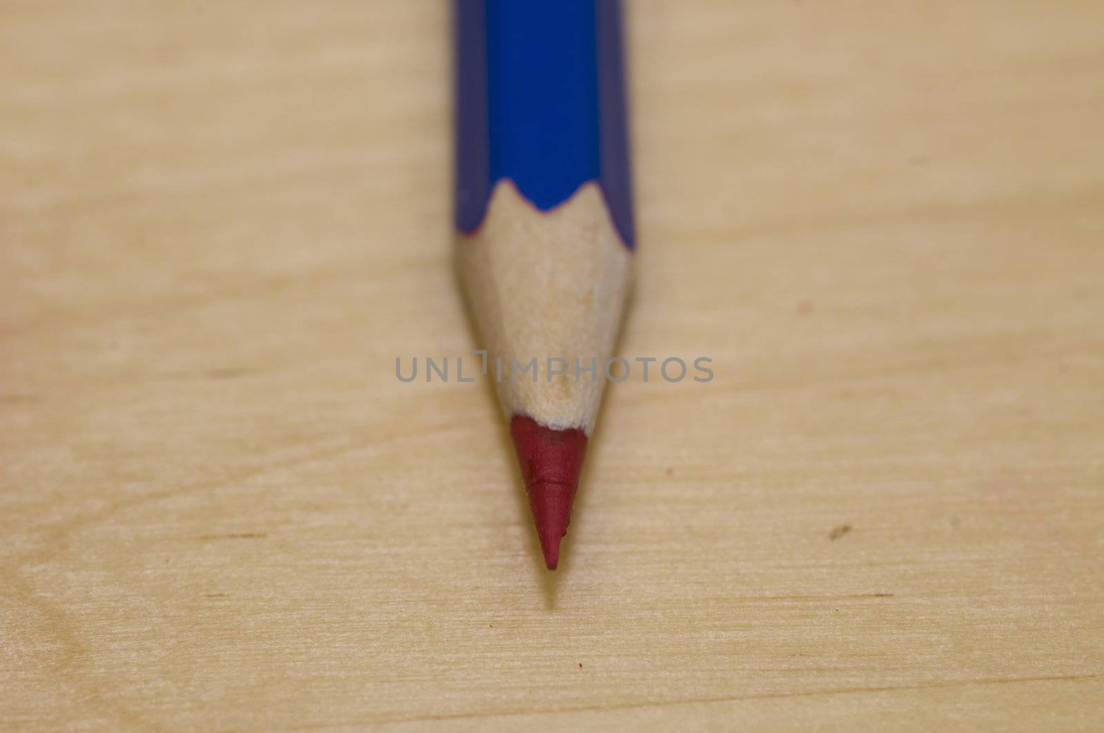 Sharpened pencil on light color wood background