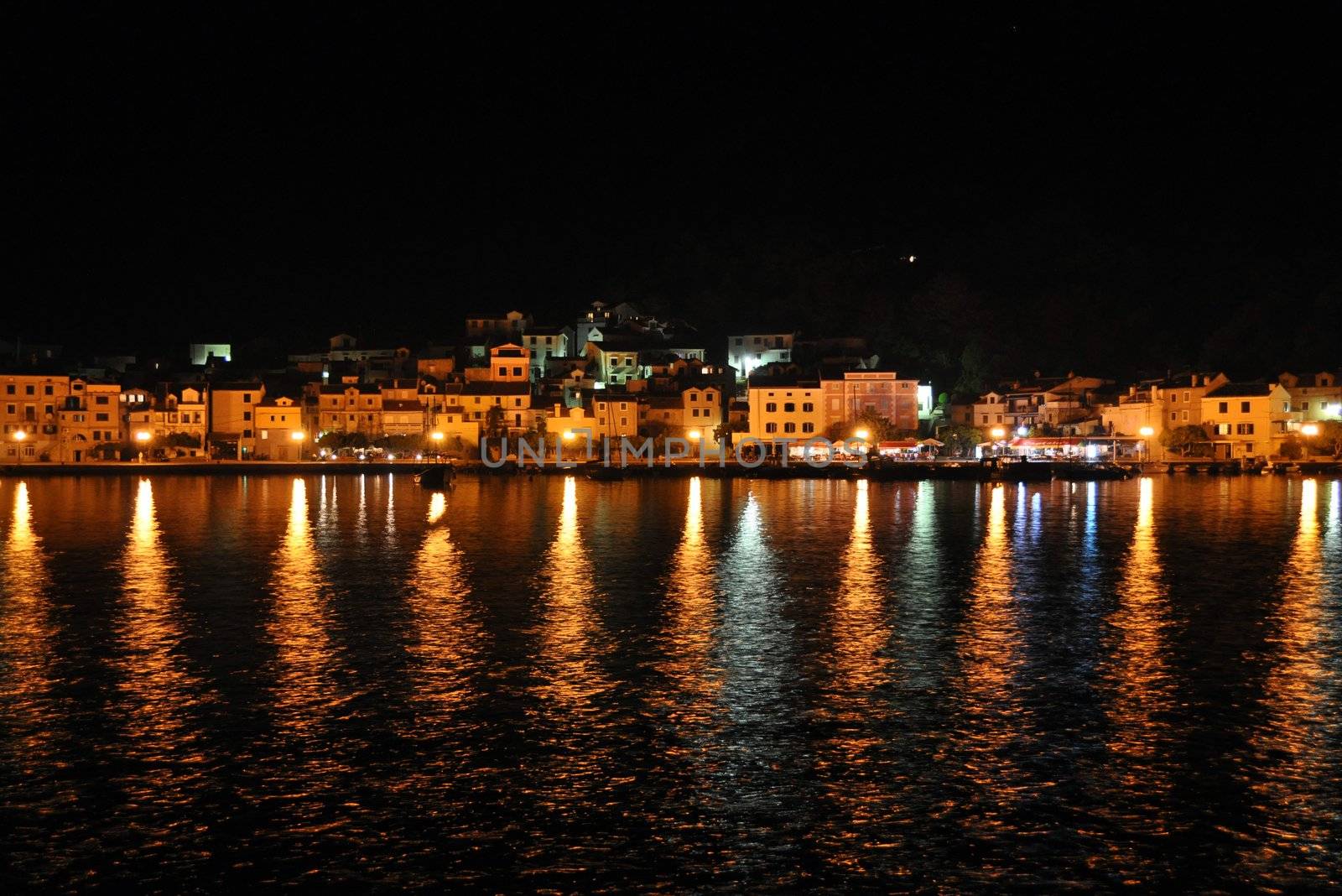 Croatian marina with village and lights in the background