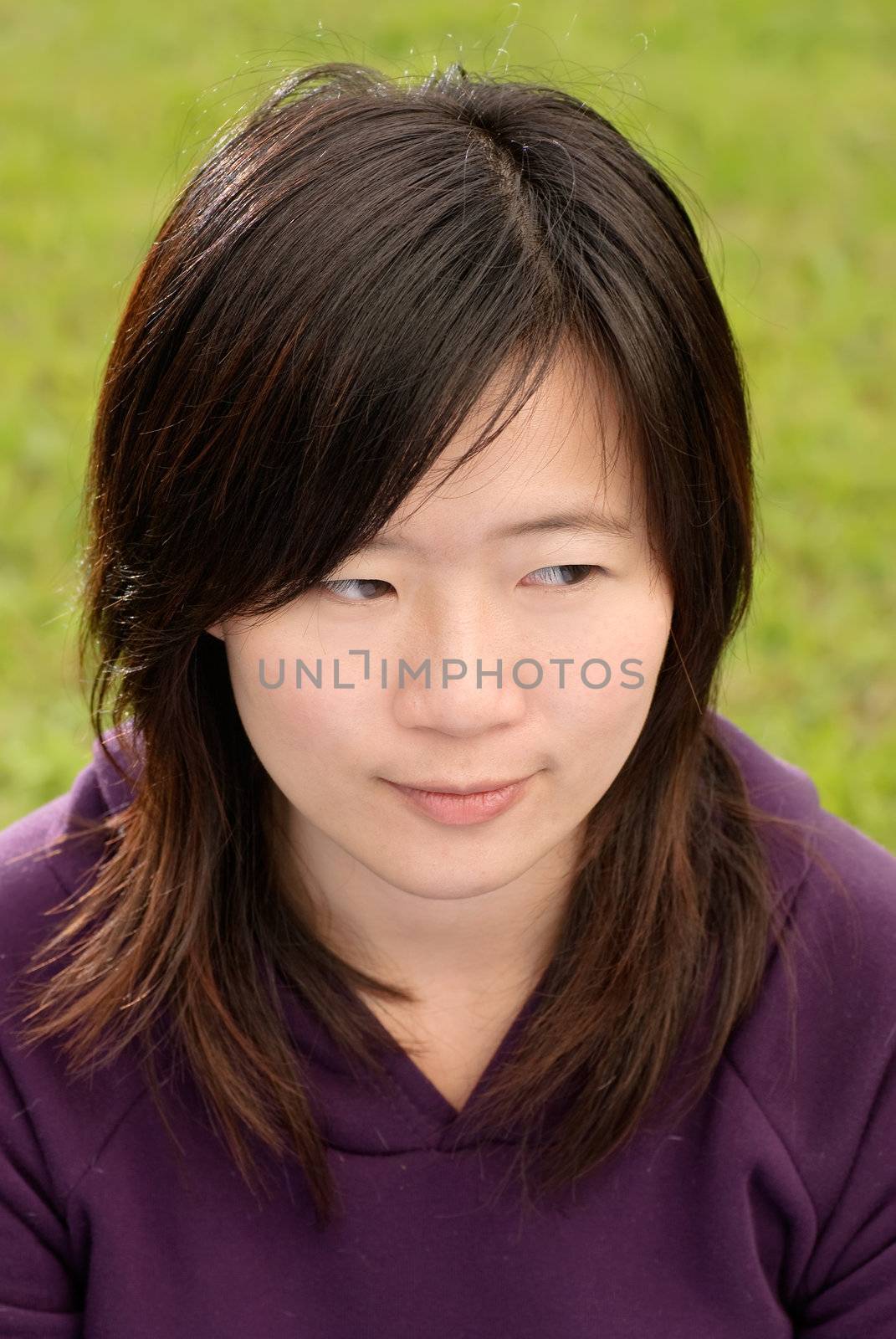 Asian beautiful woman portrait with thinking expression in outdoor of park.