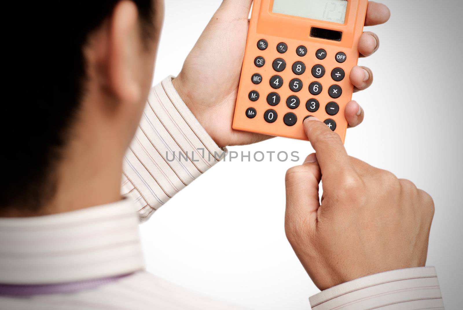 Business man use calculating machine on white background.