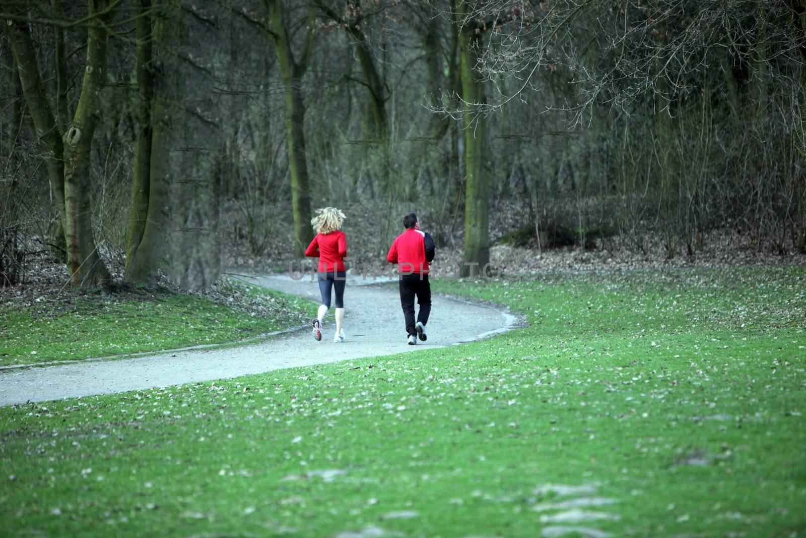 Two joggers - men and women in red sportswear