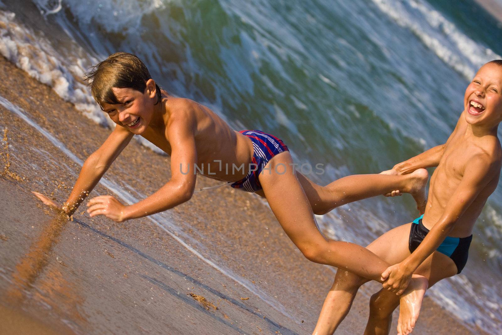 people series: two boy are play the game on sea beach