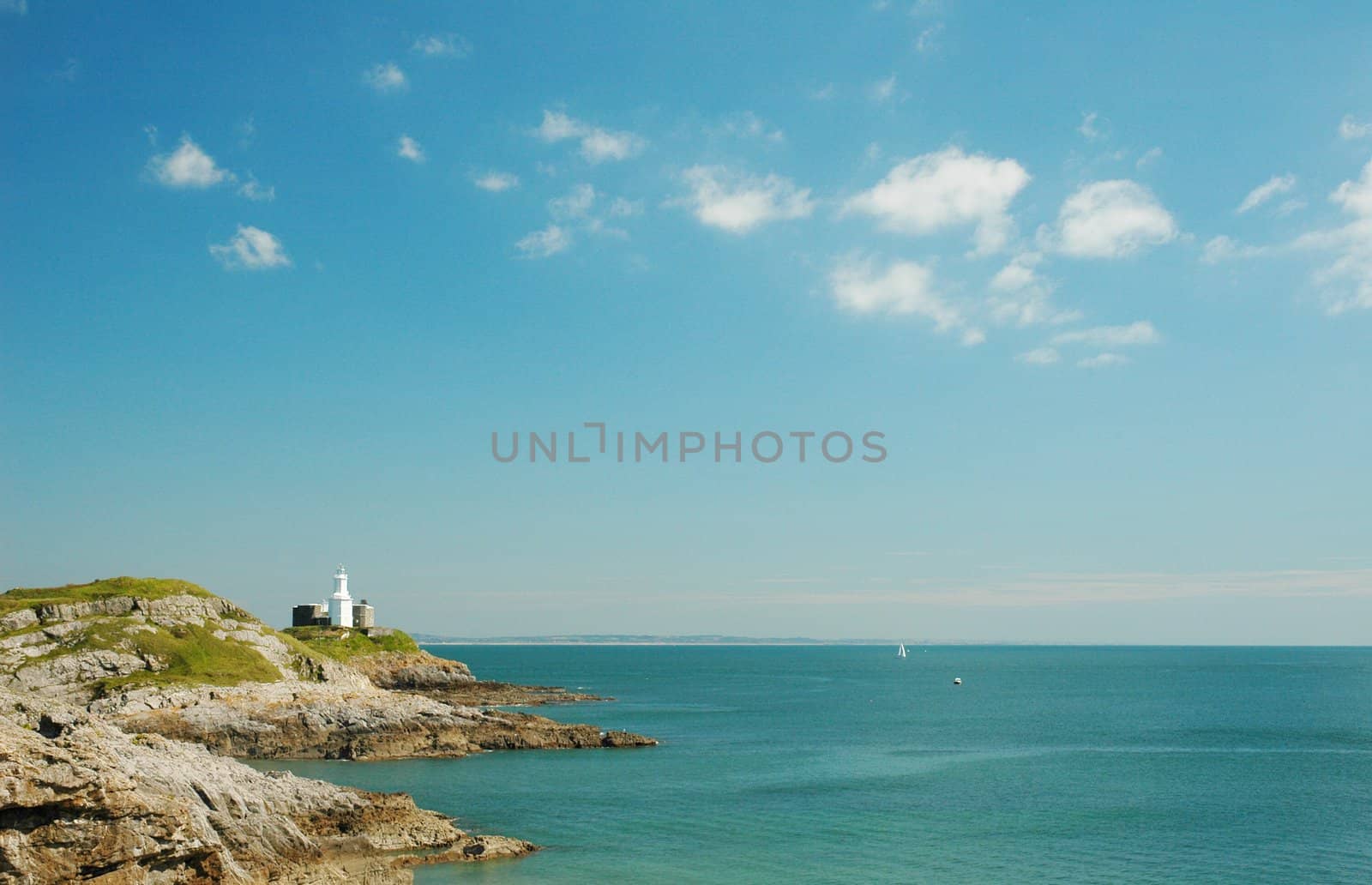 coast of Swansea in wales with lighthouse, horizontally framed shot