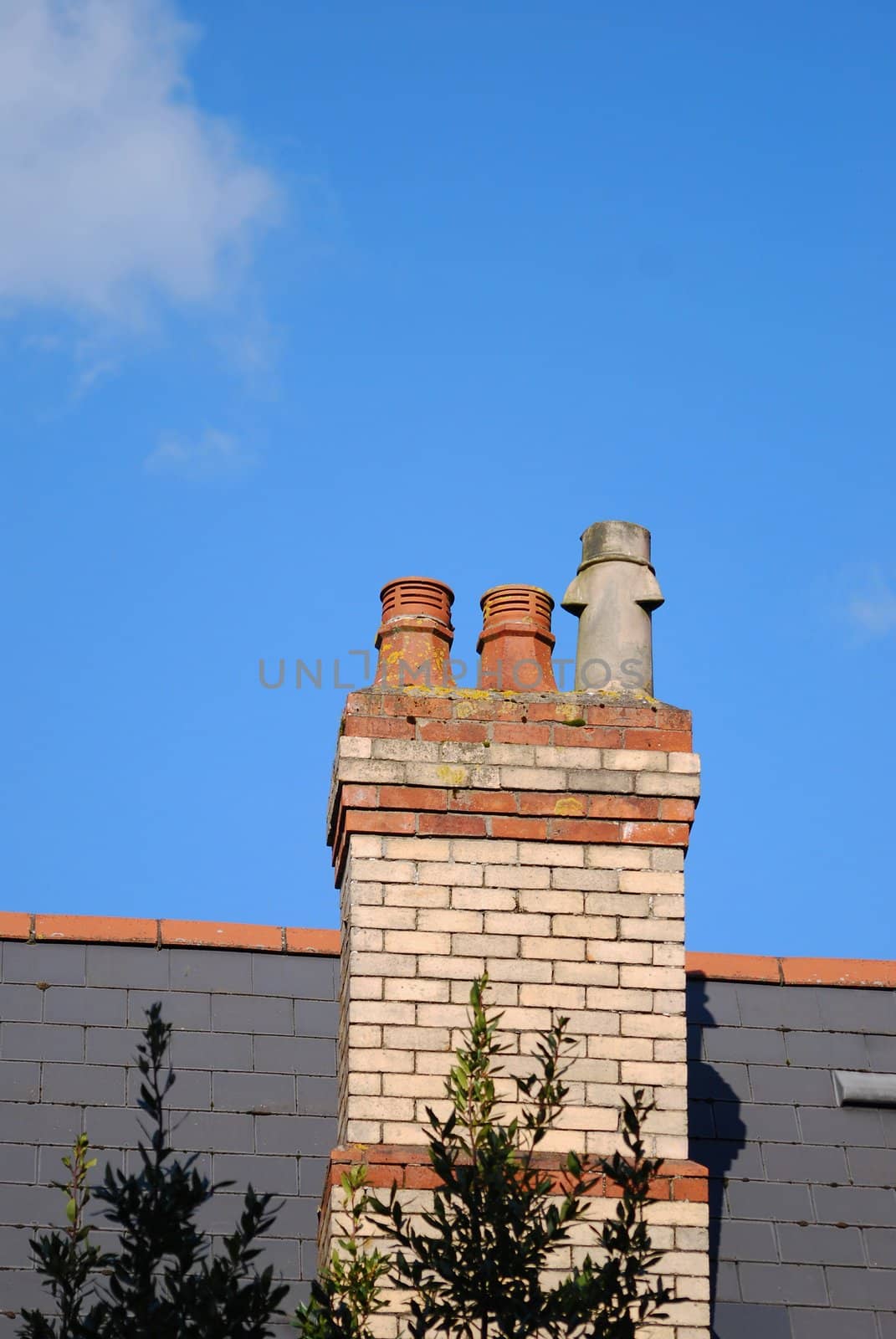 smokestacks on the roof and blue sky with white clouds