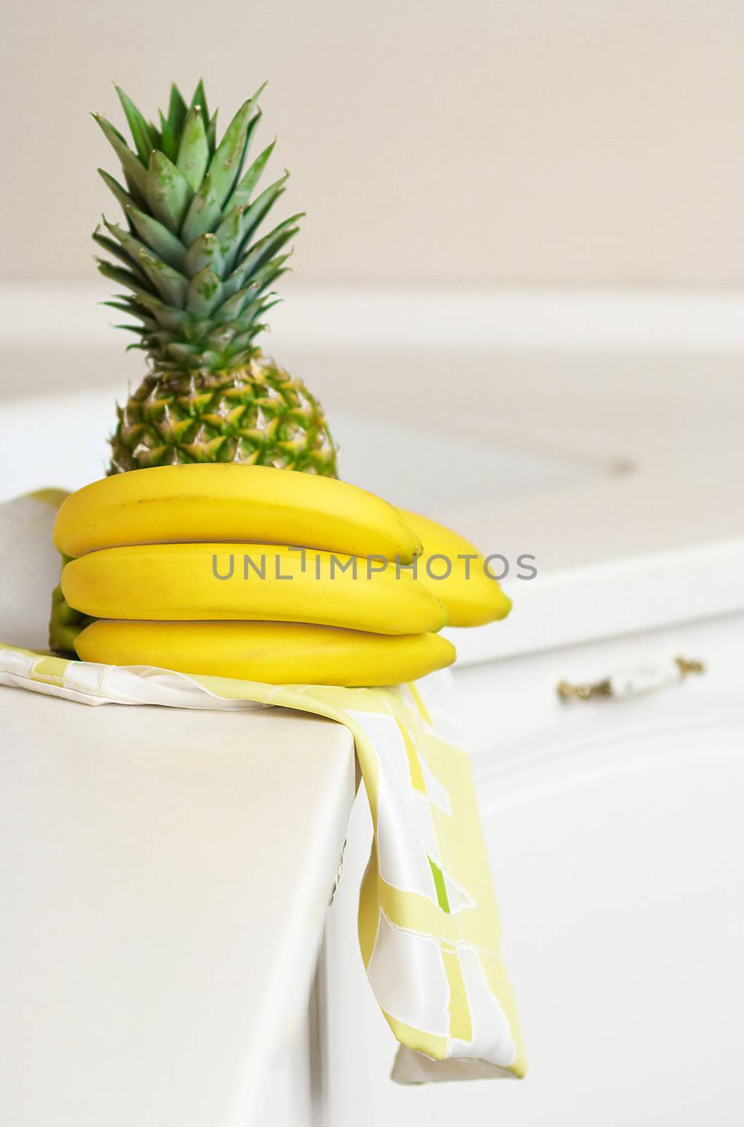 Bananas and ananas on kitchen's table by DmitryYakunin