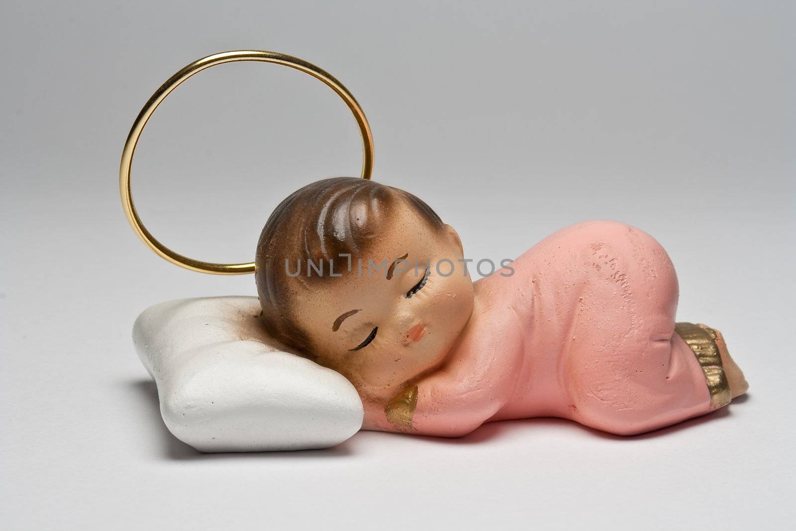 Small statue of an angel sleeping on a pillow