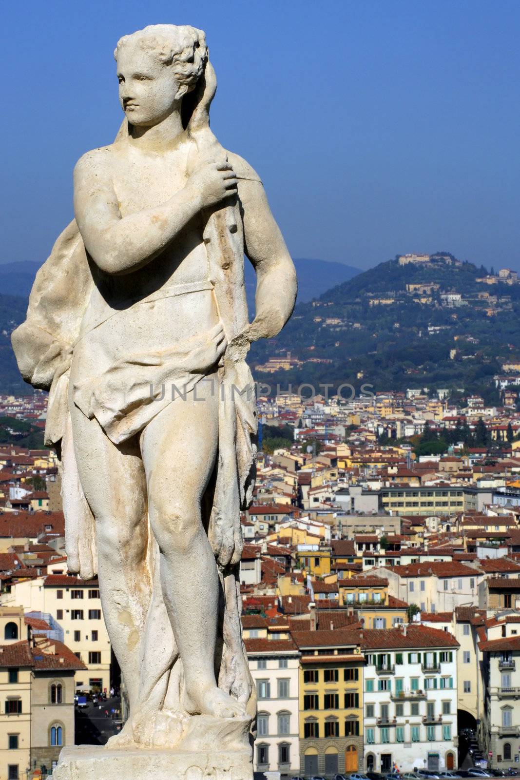 A female statue standing on a hill above Florence, Italy.
