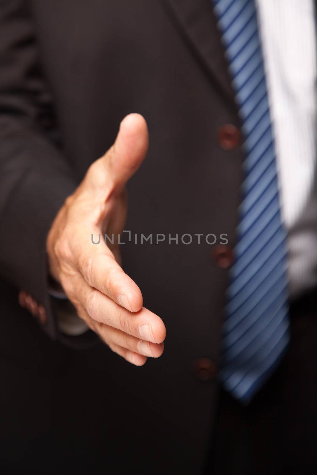 Businessman Reaching Out for Handshake by Feverpitched