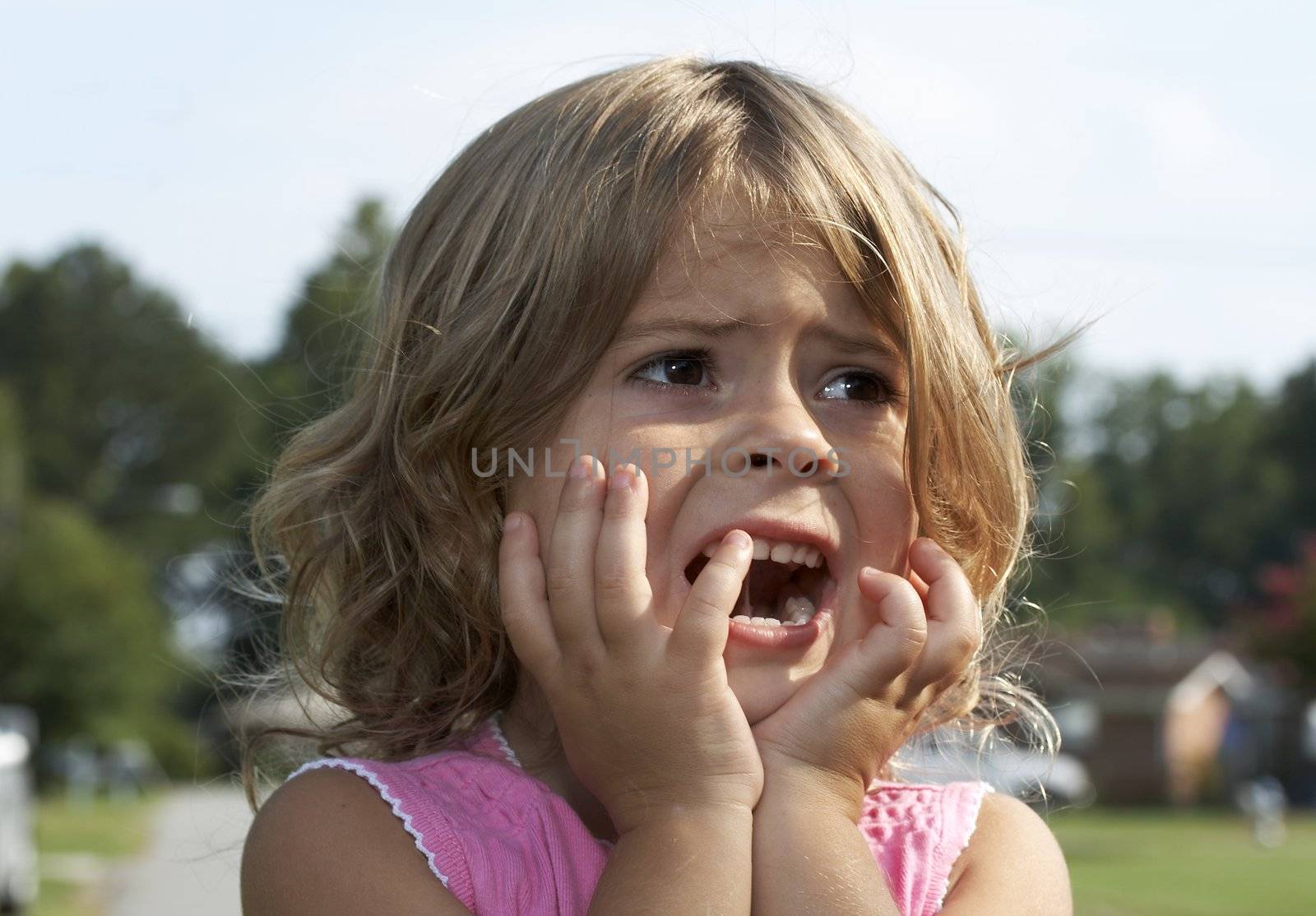 a picture of a cute little girl scared