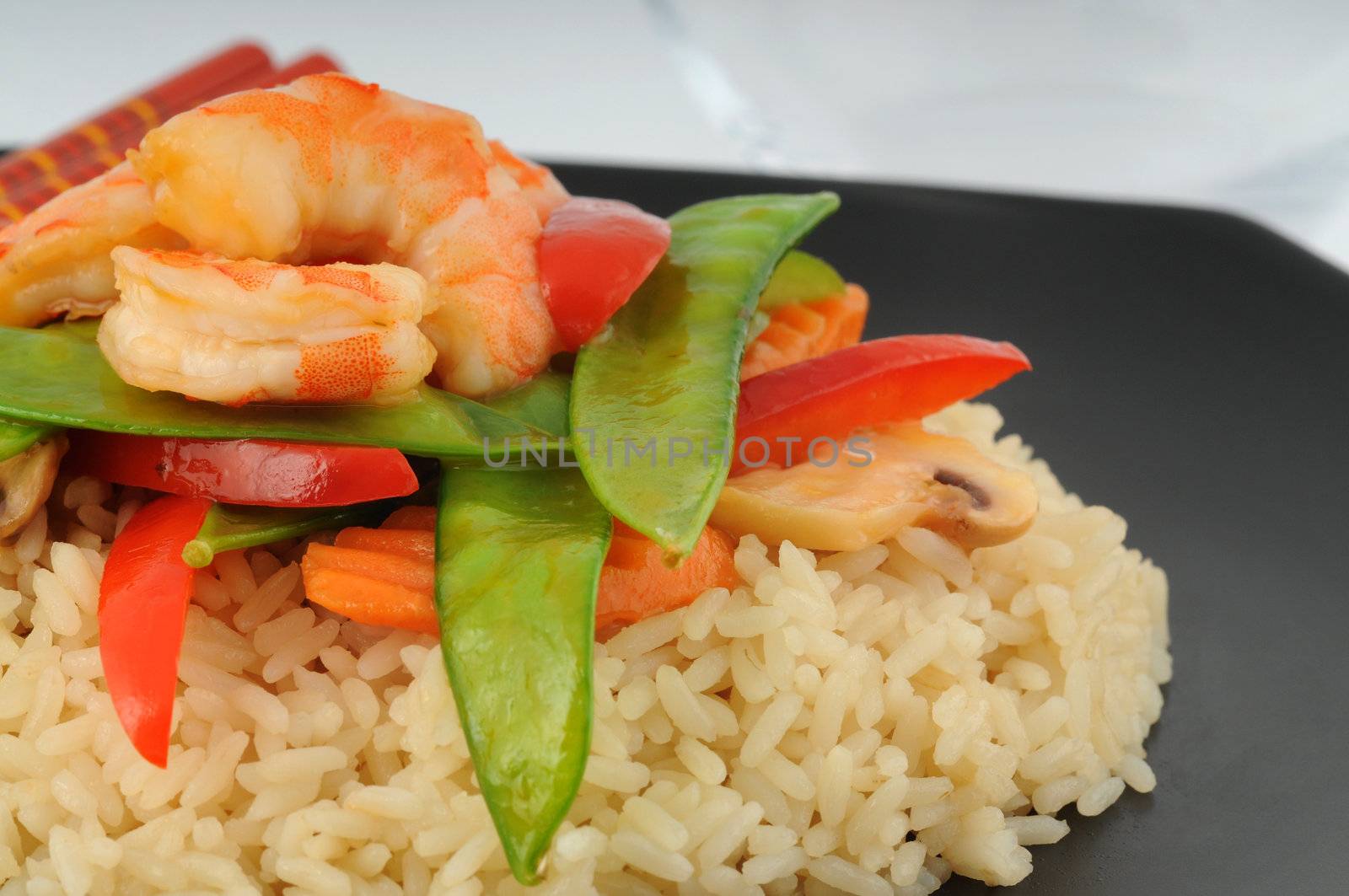 Stirfry of shrimp and vegetables on white rice.